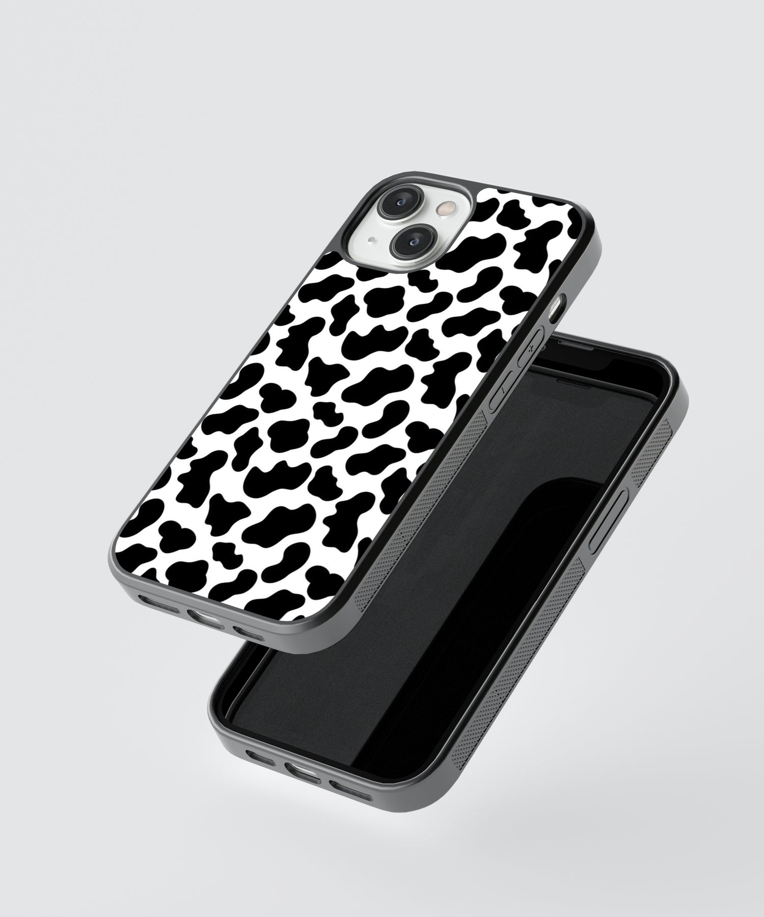 Animal print iPhone case with black and white cow pattern design and protective edges