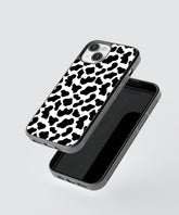 Animal print iPhone case with black and white cow pattern design and protective edges