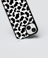Black and white animal print iPhone case with protective shock-absorbing design on a smartphone